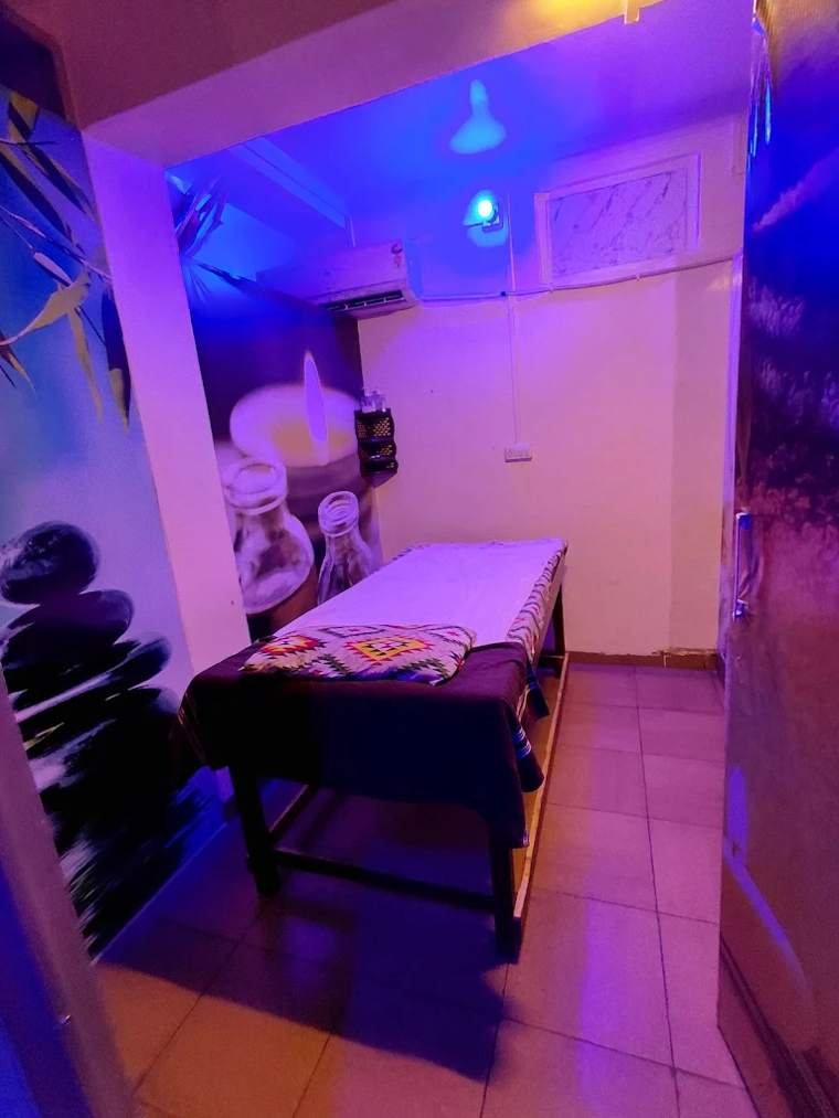 Private massage room with blue ambient lighting at Priya Gupta Spa
